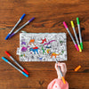 girl in pink jumper colouring in dinosaur pencil case