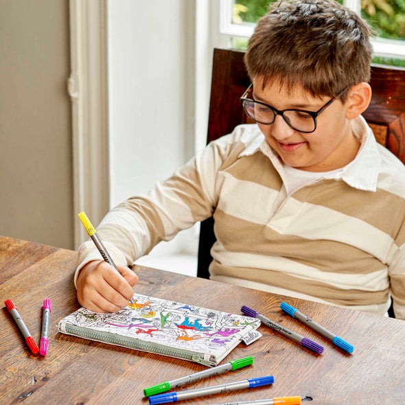 boy in brown shirt colouring in pencil case