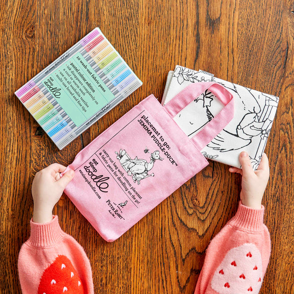 peter rabbit placemat folded and placed in pink carry bag