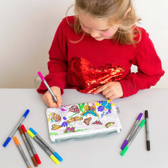 girl in red jumper colouring in