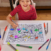 boy in red shirt looking up whilst colouring